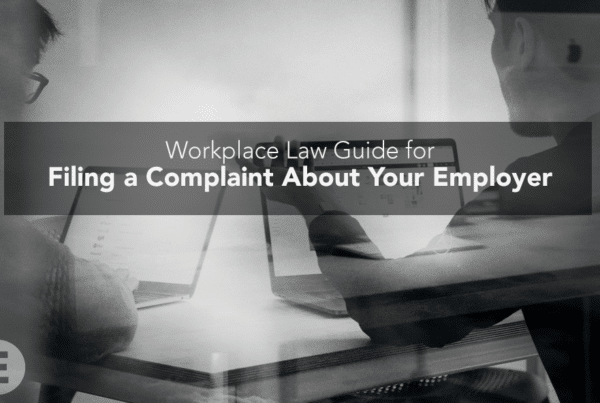 frustrated employee discussing with workmate Executive Law Group workplace law guide for filing a complaint about employers